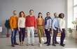 © Studio Romantic - Diverse people group of different ages, race ethnicity nationality stand in line posing for camera. Professional business team workers staff. Office studio full body shot. Gender and racial equality