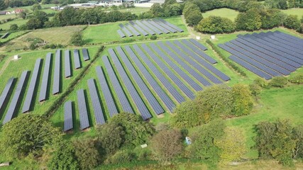 Wall Mural - Aerial view of solar power plant on green field. Electric panels for producing clean ecologic energy.