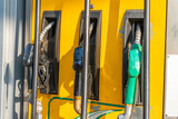 Fototapeta  - Colorful Petrol pump filling nozzles, Gas station in a service
