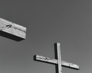 Canvas Print - Low angle greyscale view of the wooden cross against the sky