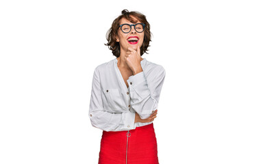 Young hispanic woman wearing business style and glasses looking confident at the camera with smile with crossed arms and hand raised on chin. thinking positive.