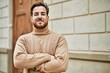 © Krakenimages.com - Young caucasian man smiling happy with arms crossed gesture at the city.