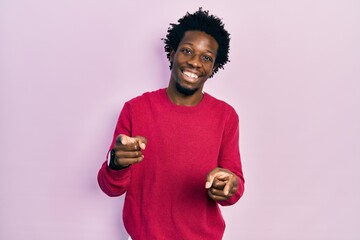 Wall Mural - Young african american man wearing casual clothes pointing fingers to camera with happy and funny face. good energy and vibes.