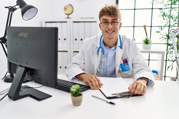 Sticker - Young caucasian doctor man working at the clinic with a happy and cool smile on face. lucky person.