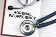 On the table is a stethoscope, a pen and a notebook in which it is written - Adrenal Insufficiency