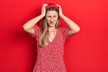 Canvas Print - Beautiful hispanic woman wearing summer dress suffering from headache desperate and stressed because pain and migraine. hands on head.