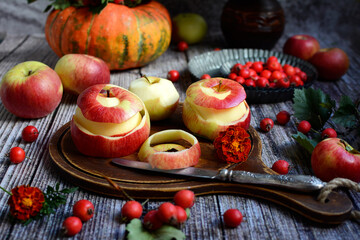 Wall Mural - Beautiful autumn still life. Juicy red apples, pumpkin, hawthorn on a rustic background