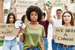© Krakenimages.com - Group of young friends protesting and giving slogans at the street thinking attitude and sober expression looking self confident