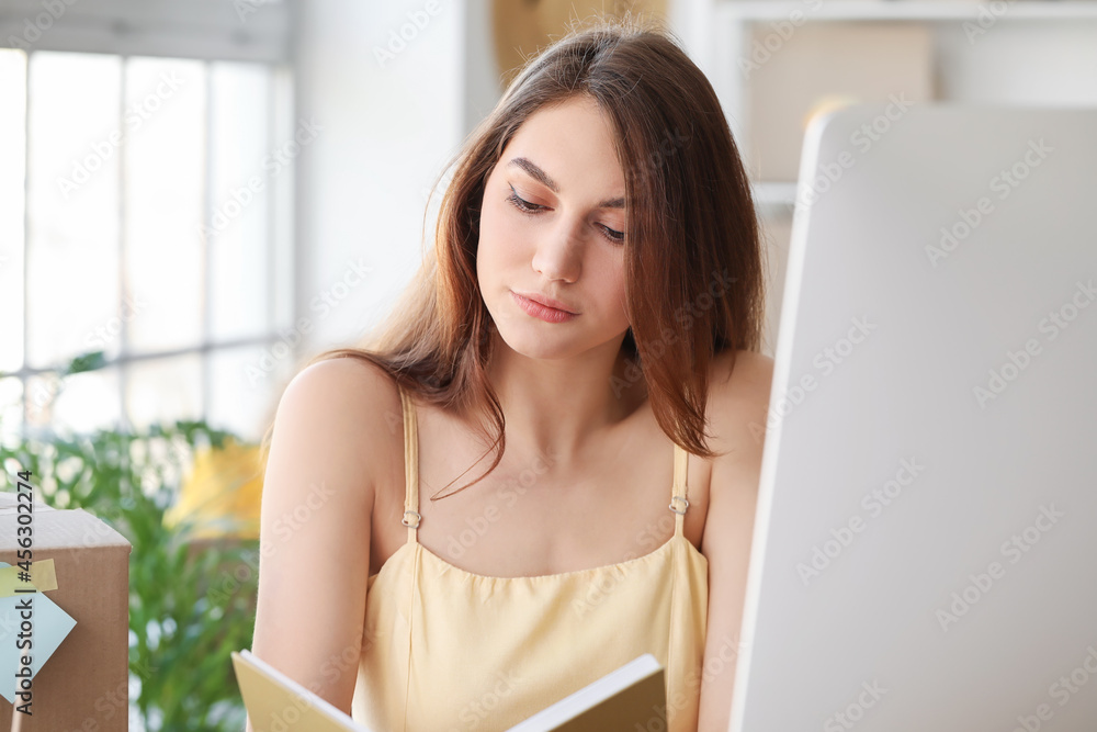 Female business owner processing order in warehouse store