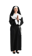 Wall Mural - Young praying nun on white background