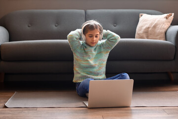 Canvas Print - Cute girl watching cartoons at home