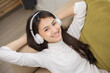 © Chanakon - Relaxing time on sofa. Beautiful young asian woman lay down on sofa and listening to the music with headphone. She has rhythm Lifestyle in living room at house in the morning.