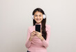 © Chanakon - Beautiful young asian women choose song and play music from smartphone connection with wireless headphone having fun in home. Teenage girl listen to the music enjoy relaxing on isolated background.
