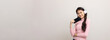 © Chanakon - Beautiful young asian women choose song and play music from smartphone connection with wireless headphone having fun in home. Teenage girl listen to the music enjoy relaxing on isolated background.