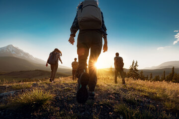 group of sporty people walks in mountains at sunset with backpacks. altai mountains, siberia, russia