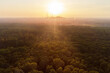 Drone view over forest and trees and an industrial area during the sunset in the ruhr area in Germany