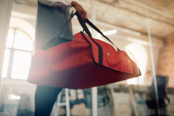 Wall Mural - Close-up of courier carries pizza in thermal bag while making food delivery.