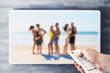 © terovesalainen - Reality tv show stream on television. Watching series on VOD streaming service. Couples at the beach or island dating, looking for love. Person using remote control. Contest or celebrity entertainment
