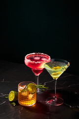 Wall Mural - Alcoholic and non-alcoholic cocktails on a dark marble table. Summer refreshments