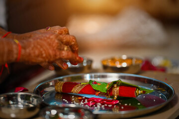 Wall Mural - Female hands with mehndi on a tray with red ornament