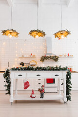 Wall Mural - White wooden kitchen interior, kitchen utensils and red Christmas decor with lights in a Scandinavian cozy style.