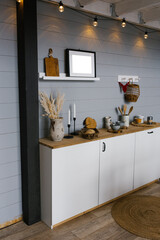 Beautiful stylish white real kitchen in Scandinavian style with wooden top and grey wooden walls