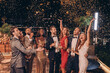 © gstockstudio - Group of happy people in formalwear having fun together with confetti flying all around