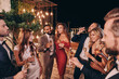 © gstockstudio - Group of beautiful young people in formalwear communicating and smiling while spending time on luxury party