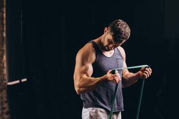 Wall Mural - Fitness man exercising with stretch rope