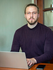 a young man is working on a computer in the office