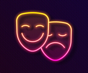 Wall Mural - Glowing neon line Comedy and tragedy theatrical masks icon isolated on black background. Vector