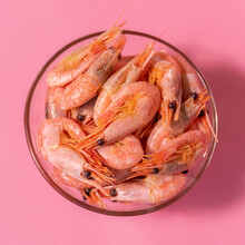 Boiled Shrimp In A Glass Bowl On A Pink Background, Top View