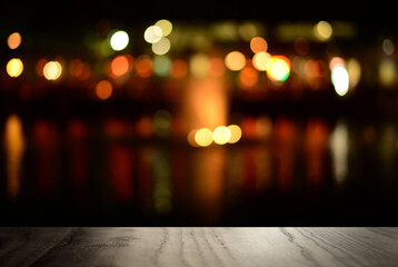 Wall Mural -  top of black wood table with bokeh light of blur pub or bar in the dark night background.