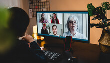 Multi Generational Business Woman Having Video Call With Colleagues Using Computer App - Focus On Mobile Phone