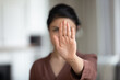© fizkes - No. Courageous young female extend hand in stop gesture oppose against domestic sexual violence abuse racial gender discrimination. Millennial lady rebel against violation of women rights. Copy space