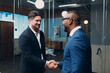 © primipil - Businessman handshake success deal team at office meeting. Business people group conference discussion sit at table with boss man shaking hands and smiles