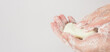 © nisara - Hands washing gesture with bar soap and foam bubble on white background.