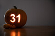31st October Halloween Calendar Date on Pumpkin with copy space on table