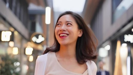 Wall Mural - pretty happy young asian woman walking in the urban city street at evening looking around enjoy the travel trip