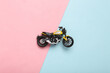 © splitov27 - Toy motorcycle model on pink blue background. Top view