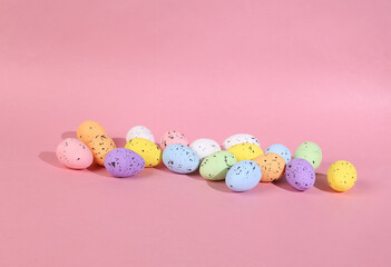 Wall Mural - Colored Easter eggs on a pink background. Minimal easter layout