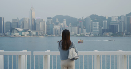 Poster - Woman look at the seaside in Hong Kong