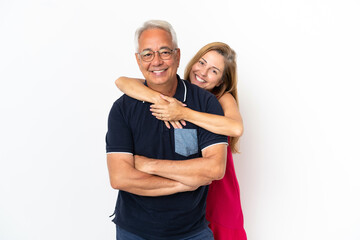 Wall Mural - Middle age couple isolated on white background laughing and hugging