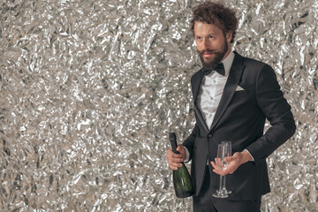 Sticker - handsome bearded man in black tuxedo holding champagne and glasses