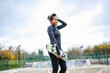 © Image Source Limited - Portrait of young female skateboarder in skateboard park