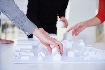 Colleagues in architect office with architectural model