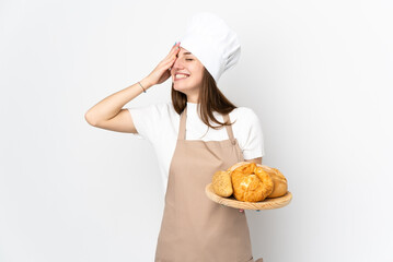 Wall Mural - Young woman in chef uniform isolated on white background laughing