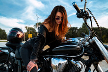 Sexy Young Woman Sitting On Motorcycle And Having Flirty Look Towards Camera 