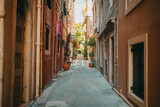 Fototapeta Na drzwi - Beautiful cozy narrow street in old town of Italy or Greece. Historic european facades of buildings. Cityscape concept.