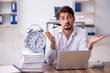 © Elnur - Young male employee in time management concept